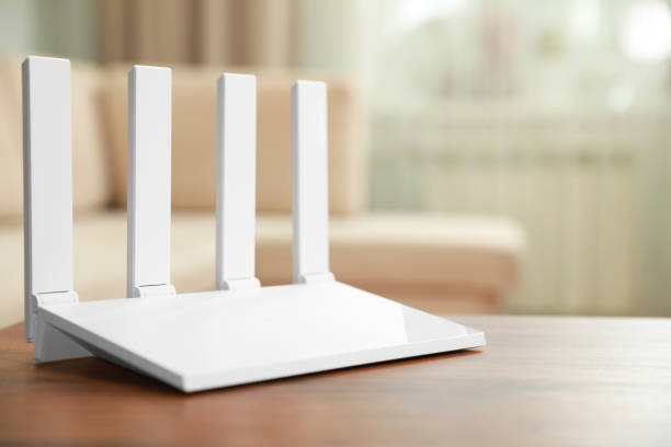 istock New modern Wi-Fi router on wooden table indoors. Space for text 1911045821