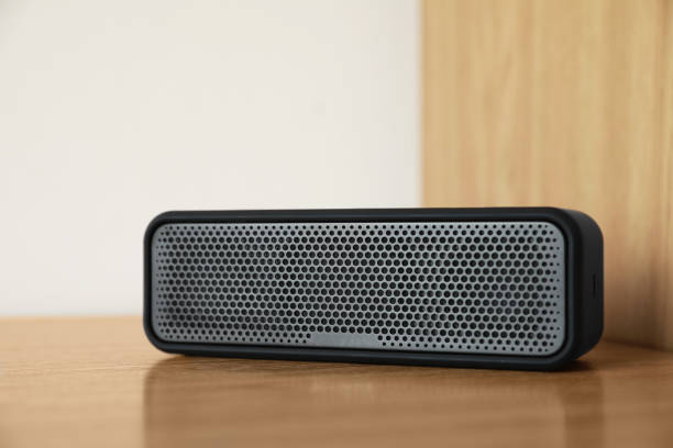 istock One portable bluetooth speaker on wooden table. Audio equipment 1911046877