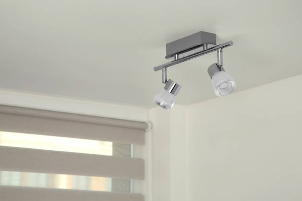 istock Stylish light fixture on ceiling indoors, low angle view 1911047435