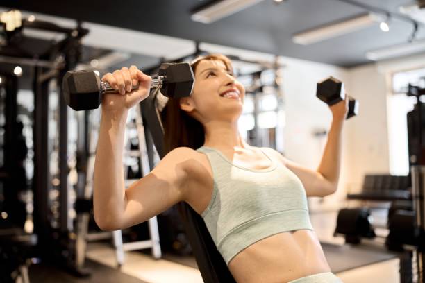 istock Woman training her chest with dumbbell presses 1911064756