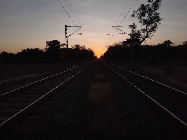 istock railway in sunset. railway track  over sunset. 1911094929