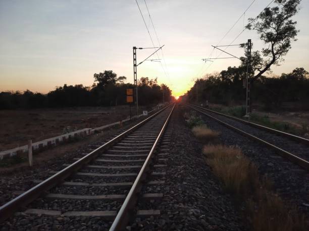 istock railway in sunset. railway track  over sunset. 1911094930