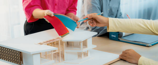 istock Architect and designer team collaborate to select house color theme. Variegated. 1911107374