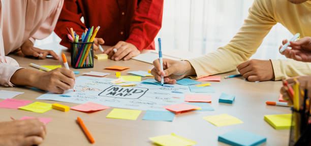 istock Creative business team brainstorming about marketing plan. Closeup. Variegated. 1911108571
