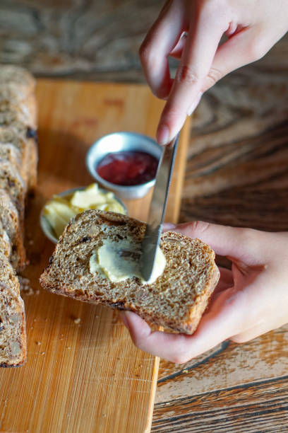 istock Spread Butter on a Slice of Bread 1911109599