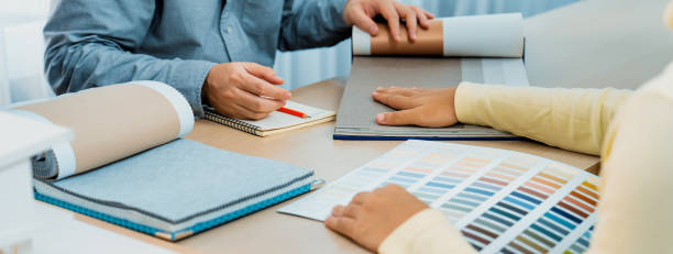 istock Architect and interior designer discussing about curtain material. Variegated. 1911111161