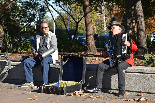 Houston, TX 12-27-2023 - Street performers entertain fellow pedestrians with a song while playing instruments at Hermann Park in Houston.