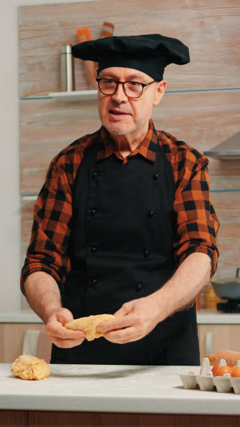 istock Grandfather recording food video in kitchen 1911259364