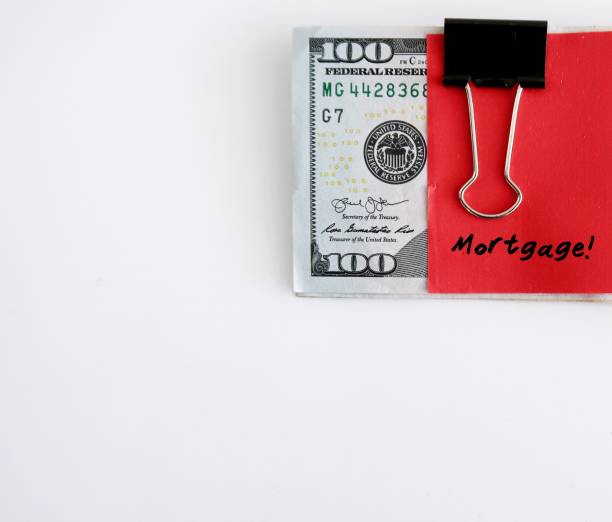 istock A red paper note clipping on dollars bank notes with handwritten text MORTGAGE, concept of saving or set budget for house loan or mortgage payment - on white background can used as copy space 1911263631