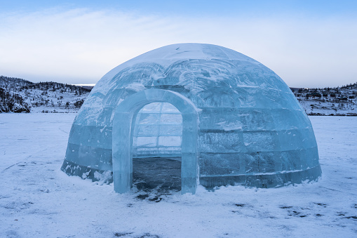 A winter scene with a snow igloo. A real igloo snow house.  Igloo Icehouse. Selective focus.