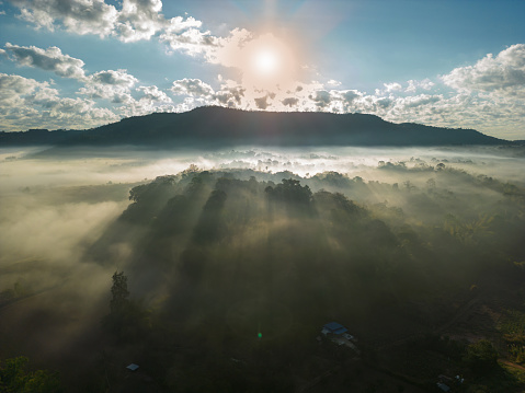 Aerial view of flowing fog waves on mountain tropical rainforest.Top view.Khao Kho, Phetchabun, Thailand.