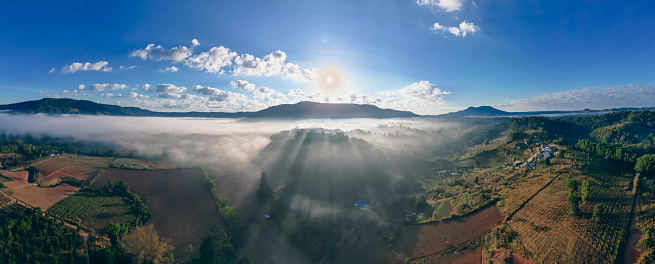 Panorama aerial view  of flowing fog waves on mountain tropical rainforest.