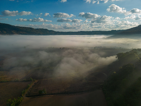 Aerial view  of flowing fog waves on mountain tropical rainforest.Khao Kho, Phetchabun, Thailand.