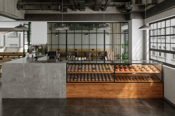 istock Empty Coffee Shop With Coffee Maker, Wooden Tables, Pastries And Pendant Lights 1911361178