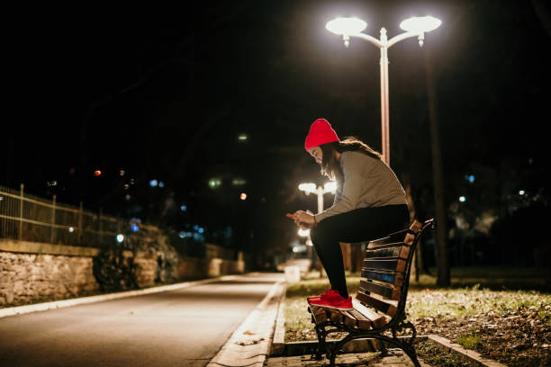 a young woman sits on a bench and rests after running
