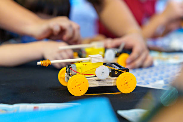 istock The close-up view showcases a student diligently working on a DIY robotic car, capturing the essence of coding, technology, robotics, and science. 1911397932