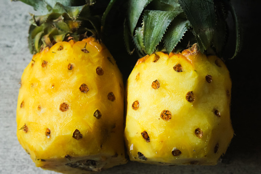 two peeled pineapples