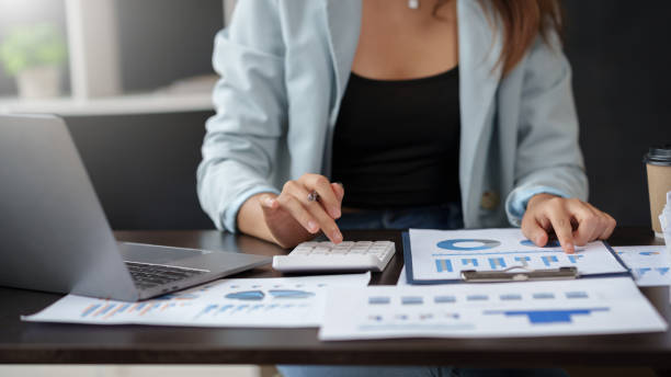 istock Auditor is examining the financial statement documents using a calculator calculate monthly expenses, manage budget, income tax, budget, documents, credit documents, invoices. 1911400635