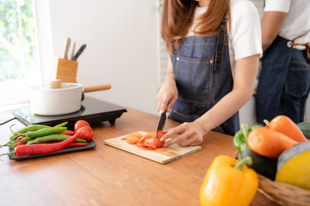 istock Woman preparing food in kitchen at home. 1911415537