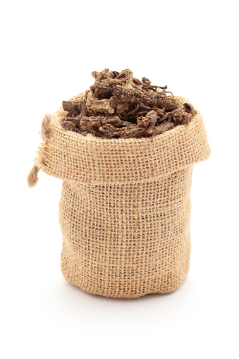 Close-up of Dry organic Sugandha Bala (Pavonia Odorata) roots, in a jute bag. Isolated over a white background.