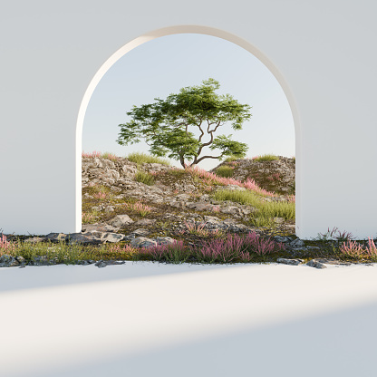 Rocky hill landscape with tree and pink flowers seen through an archway