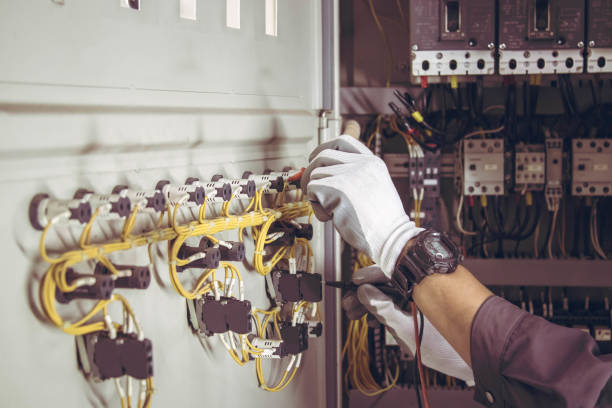 istock Electrician engineer tests electrical installations and wires on relay protection system. 1911474004