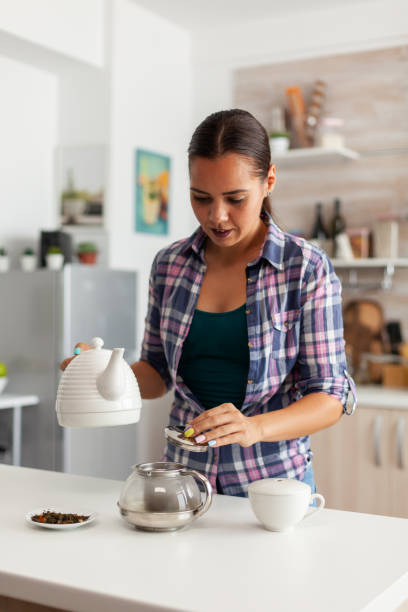 istock Housewife preparing hot drinkg 1911487159