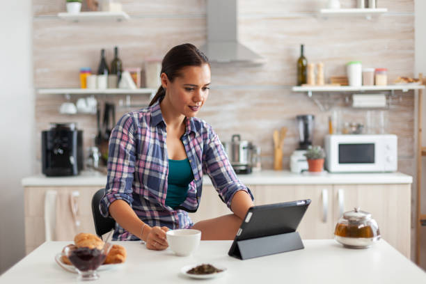 istock Woman reading news on tablet 1911493422