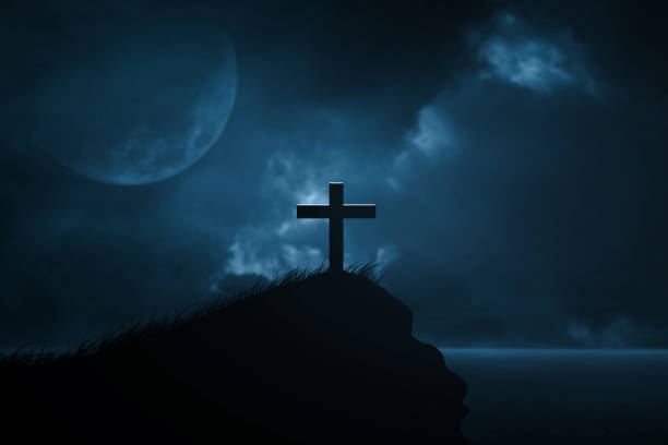 istock 3D Rendering Silhouette christian crosses on the rocks night sky clouds with half moon 1911497690