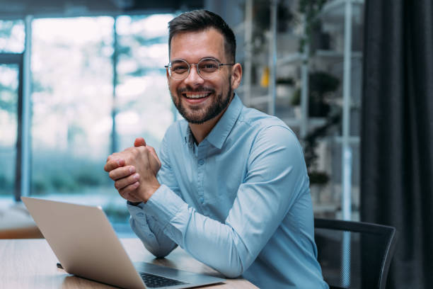 successful businessman in modern office working on laptop. - satu orang jumlah orang foto potret stok, foto, & gambar bebas royalti