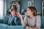 Stressed mother having problem with noisy naughty daughter.