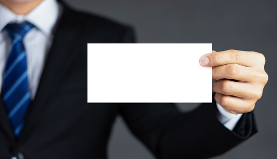 Businessman holding blank advertisement card with copy space