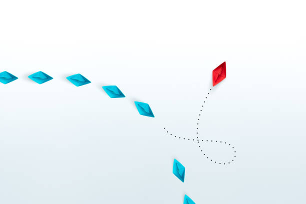 istock Business for new ideas creativity, innovative and solution concepts. Group of blue paper ships in one direction and one red paper ship pointing in different way on white background. copy space 1911524417