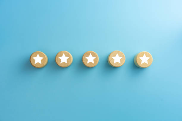 istock Five star symbol on wooden cubes on blue background. Customer experience, satisfaction survey, Evaluation, Increase rating and best excellent services rating concepts. 1911526205