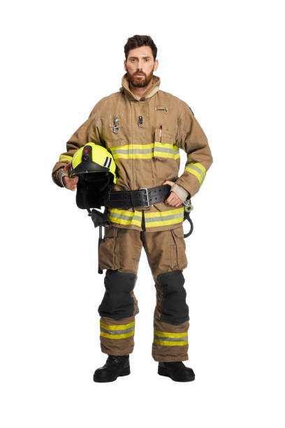 istock Serious handsome firefighter in uniform with protective helmet. 1911548035