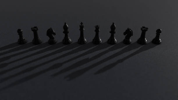 shot of black chess pieces with dramatic light moving and creating moving dramatic shadows - checking the time imagens e fotografias de stock