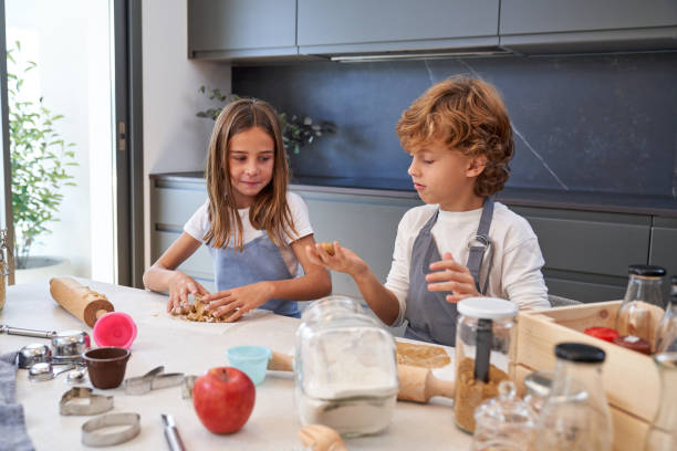 istock Children preparing dough for cookies 1911577909