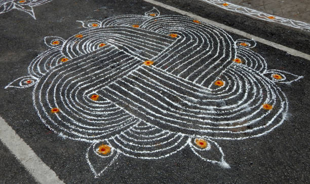 Indian Hindu traditional rangoli drawn by women in front of temples and homes Close-up view of Indian Hindu traditional rangoli drawn by women in front of temples and homes pookalam stock pictures, royalty-free photos & images