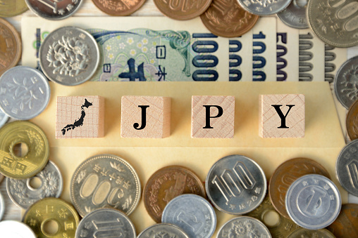Japanese money and wooden blocks with JPY word