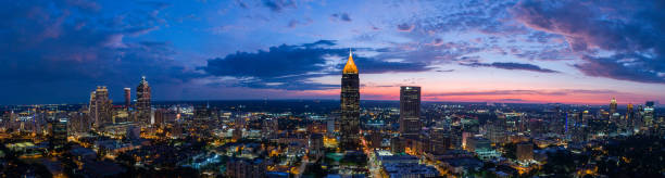 Arial Shots of downtown Atlanta and dramatic sky Downtown Atlanta and ATT building at dusk with dramatic colors and city lights. atlanta skyline stock pictures, royalty-free photos & images