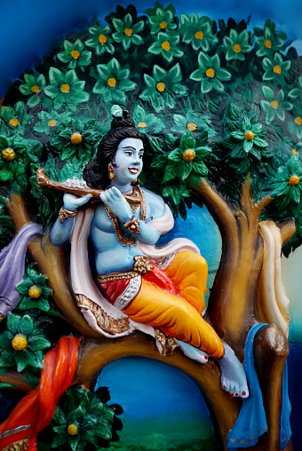 Wall art or mural applied to and made integral with a wall of Indian Hindu God Krishna in a temple