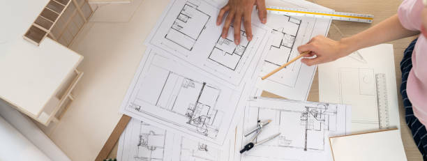 istock Blueprint architectural document scatter around on meeting table. Burgeoning. 1911615438