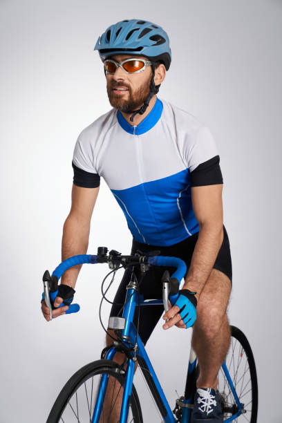 istock Triathlon male cyclist in full equipment training indoors. 1911626457