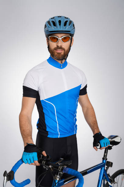 istock Professional cyclist in full gear, posing with bike in studio. 1911629058