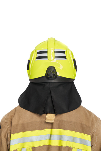 Unrecognizable firefighter in yellow protective helmet and uniform in studio. Back view of anonymous male fireman in full gear, with copy space, isolated on white background. Fire equipment concept.