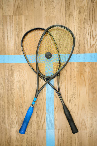 istock Rocket with ball on beige squash indoor court copy space 1911636519
