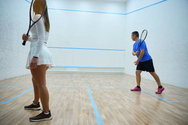 istock Demonstrative man trainer showcases hitting precision in squash game 1911636951