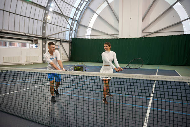 istock Woman player and man coach refining their strokes and footwork with precision 1911637560