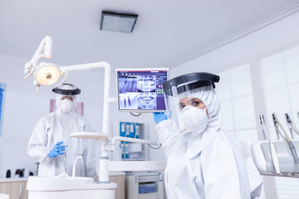 istock Doctor showing to X Ray on dental unit 1911660120