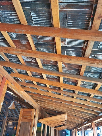 Bandung, Indonesia - Jan 06, 2024: Picture of under the roof of Javanese traditional house made of wood and clay roof